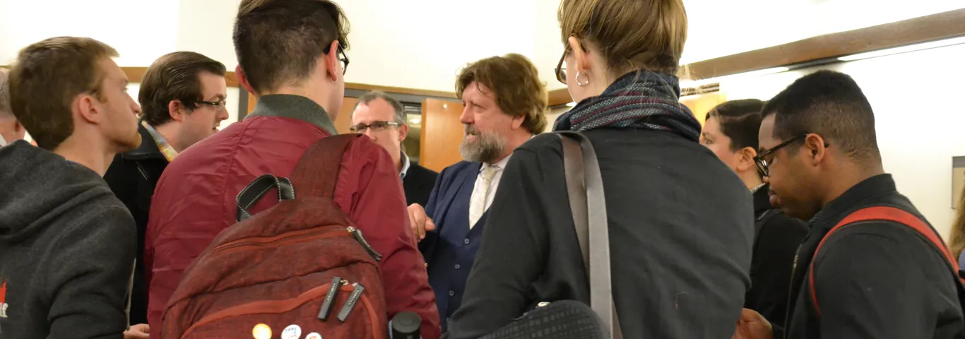 Oskar Eustis visits with graduate students after his March 2018 Helen Clanton Morrin lecture.